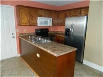 Kitchen nook with stainless appliances. Large walk-in pantry to right of photo.