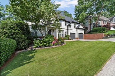 View of front facade with driveway, stucco siding, a front lawn, and a garage