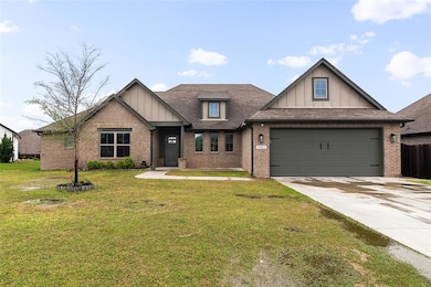 Craftsman-style home with brick siding, a garage, 