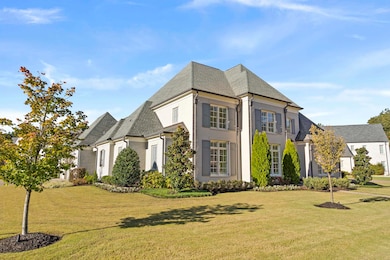 View of front of property with a front lawn, roof with shingles, and brick siding