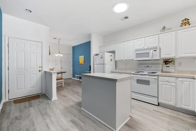 Kitchen featuring white appliances, visible vents,