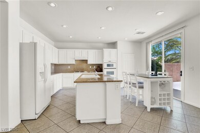 Kitchen with white appliances, recessed lighting,