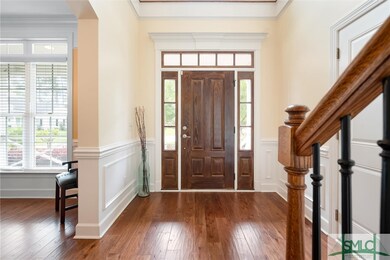 Two story foyer entry way with wood flooring and j