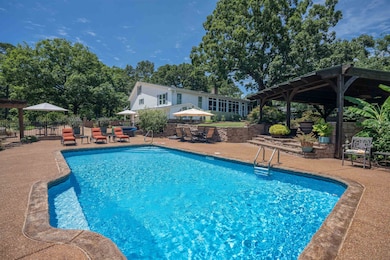 View of swimming pool with a patio and a gazebo