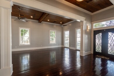 Foyer with the massive metal front doors with thei