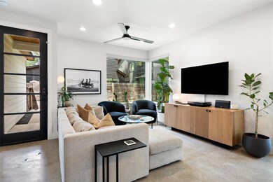 Living area with concrete floors, recessed lighti