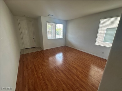 Unfurnished room with wood finished floors and bas