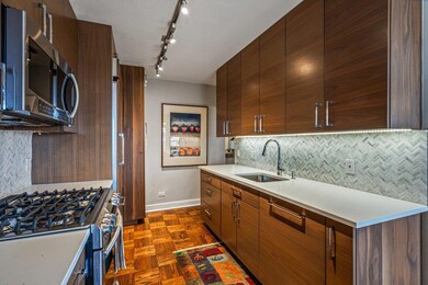 Kitchen featuring a sink, decorative backsplash, modern cabinets, and stainless steel appliances