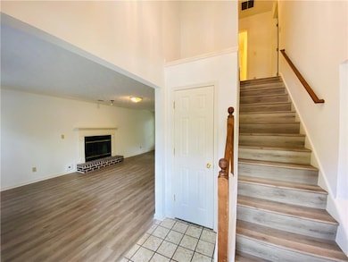 Staircase featuring tile patterned flooring, a bri