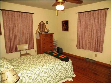 bedroom 1 with hardwood floors