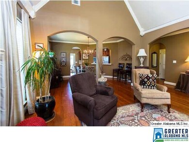 The great room is cozy, with a rustic stacked ston