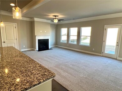 Unfurnished living room with ceiling fan, ornament
