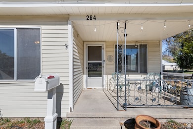 View of exterior entry featuring covered porch