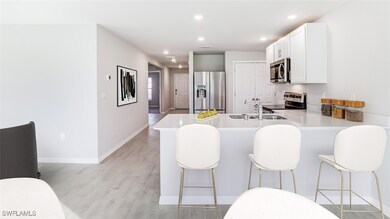 Kitchen with stainless steel appliances, a peninsu