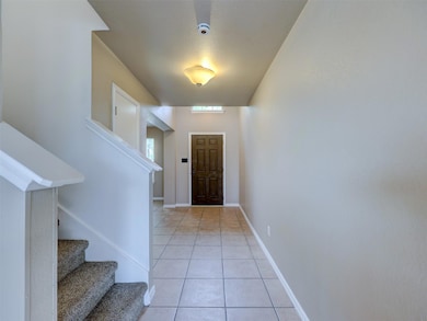 Entrance foyer with stairs, baseboards, and light
