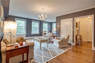 Spacious living room with wall of windows makes this charming space light and inviting.