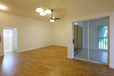 Empty room featuring a chandelier, hardwood / wood