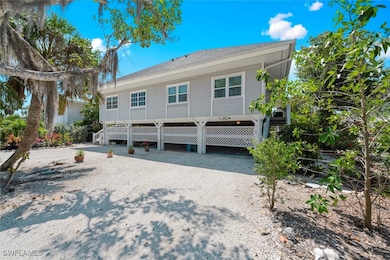 View of front of property with a carport, driveway