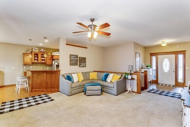Neutral carpet, ceiling fan & open floor plan