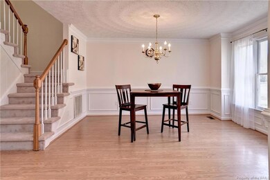 Formal Dining Room with stylish wainscoting, crown molding and plenty of natural light