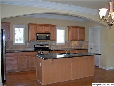 The gourmet kitchen includes a large breakfast bar