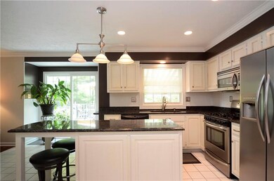 The kitchen includes granite countertops and stain