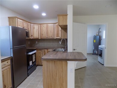 Kitchen with washer / dryer, sink, stainless steel