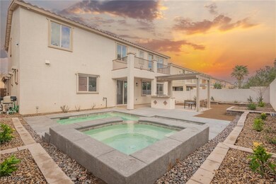 Back of house with a balcony, a patio, stucco sidi