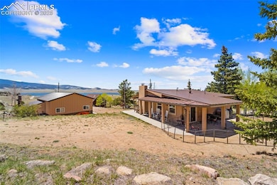 Rear driveway to the home with back patio and water views.