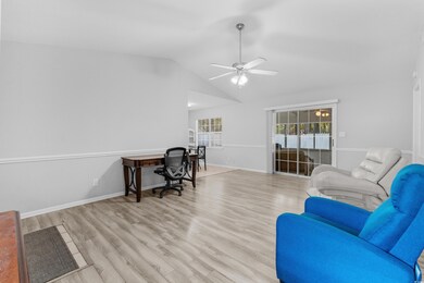 Office featuring light wood-type flooring, vaulted