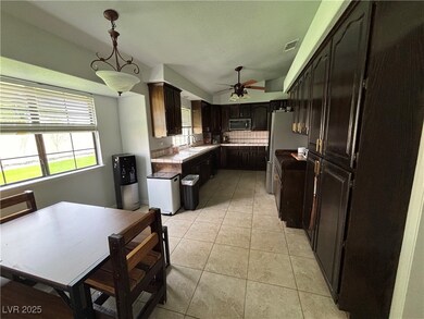 Kitchen featuring light tile patterned floors, a s
