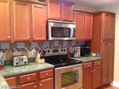 Kitchen. Kitchen with cherry cabinets and stainless steel appliances.