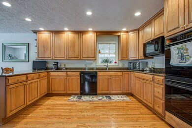 The large kitchen features granite counter tops and maple cabinets.  