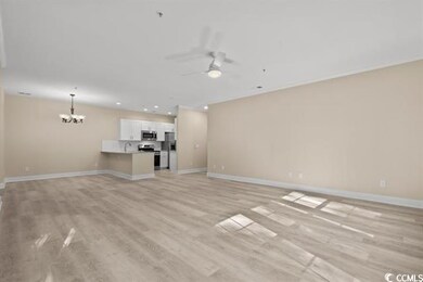 Unfurnished living room featuring ceiling fan, a chandelier, baseboards, light wood finished floors, and recessed lighting