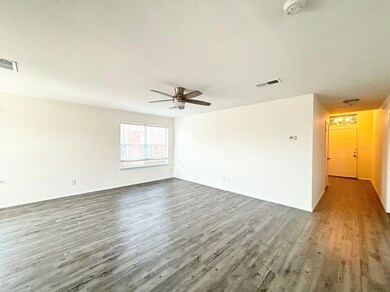 Spare room featuring ceiling fan, hardwood / wood-