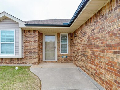 Doorway to property with roof with shingles and br