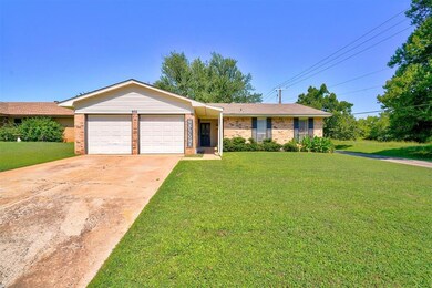 Ranch-style home with a garage and a front lawn