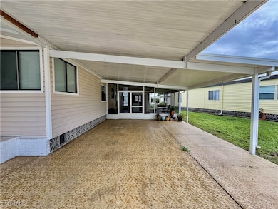 View of patio featuring a sunroom and a carport