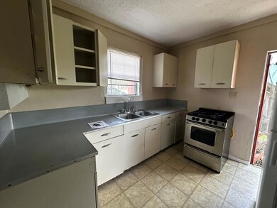 Kitchen featuring stainless steel gas range, a te