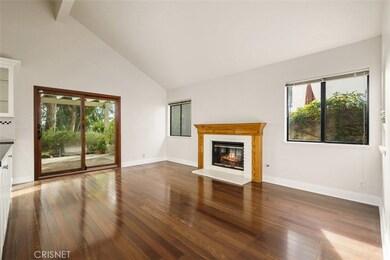 Family room warmed by the fireplace and sliding glass doors open to tranquil patio areas