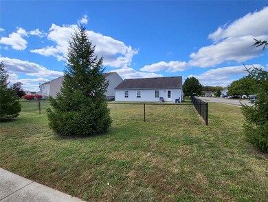 Beautiful pine trees line the back of the lot