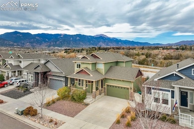Front Exterior – Elevated View – Overhead view capturing the full roofline and porch, along with a peek at the surrounding neighborhood setting.