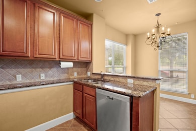Kitchen with stainless steel dishwasher, a sink, 