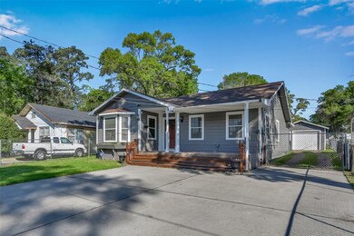 Lots of space to park cars: garage, driveway beside house, and wide parking area in front of house