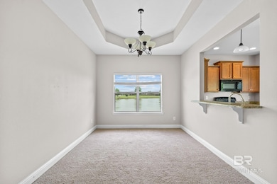 Unfurnished formal dining room with chandelier and view of community's water feature.