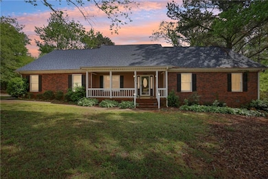 Ranch-style house featuring brick siding, a porch,
