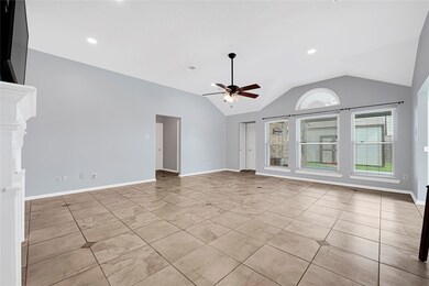 Spacious living area with high ceilings and a wall