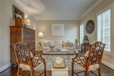 Living room featuring crown molding and hardwood f