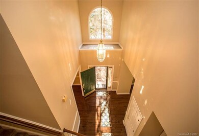Two-story entrance with large arched window provid