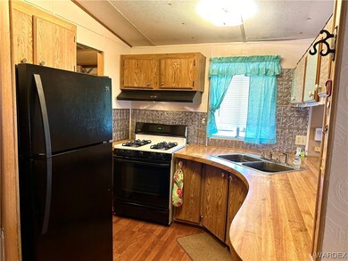 Kitchen with gas range oven, refrigerator, formica
